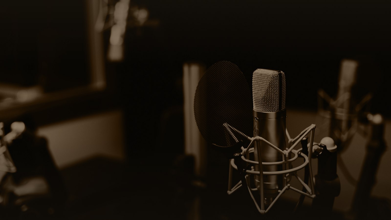 Sepia-toned photo of a studio microphone in a dark room